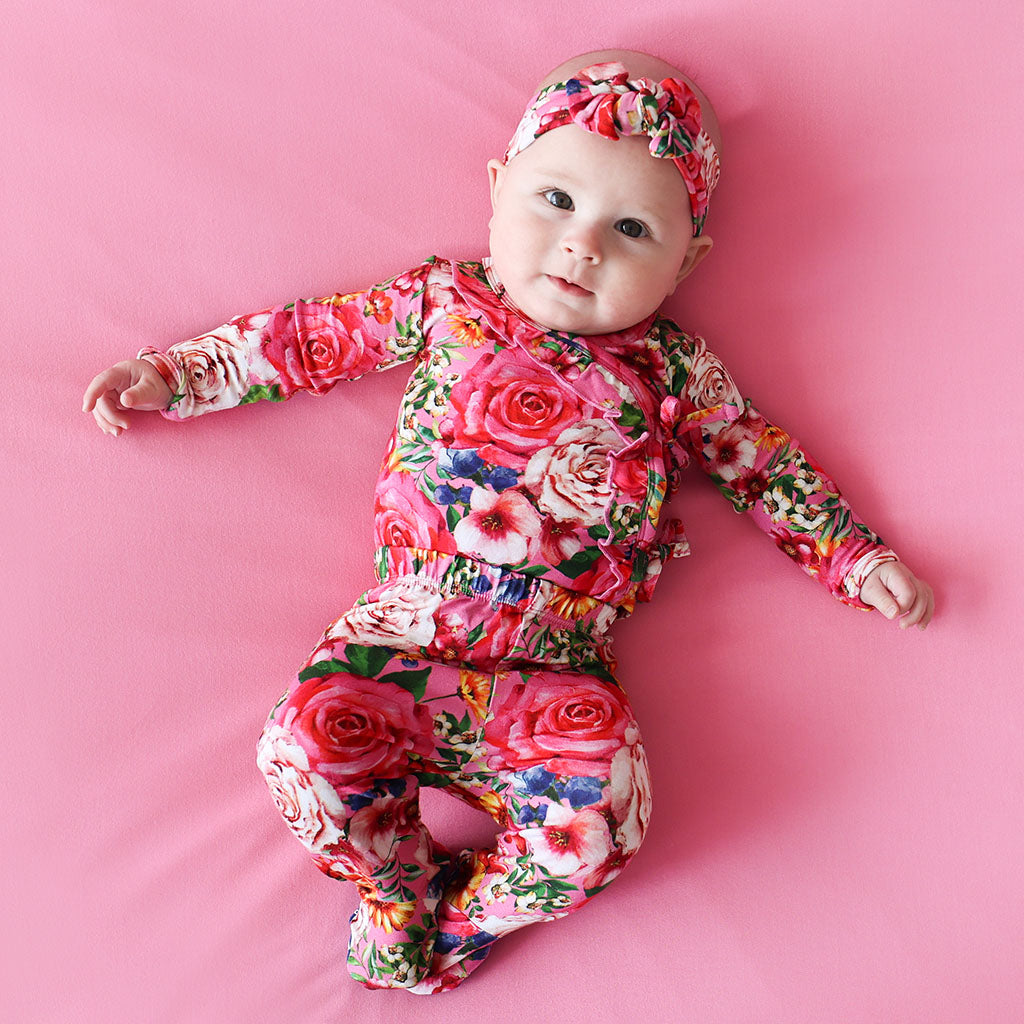 child crawling in floral bodysuit dress for baby