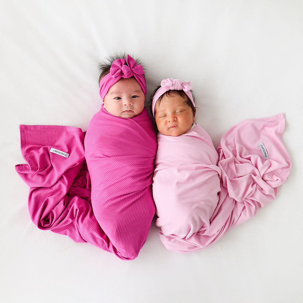 mother holding child in floral baby one piece