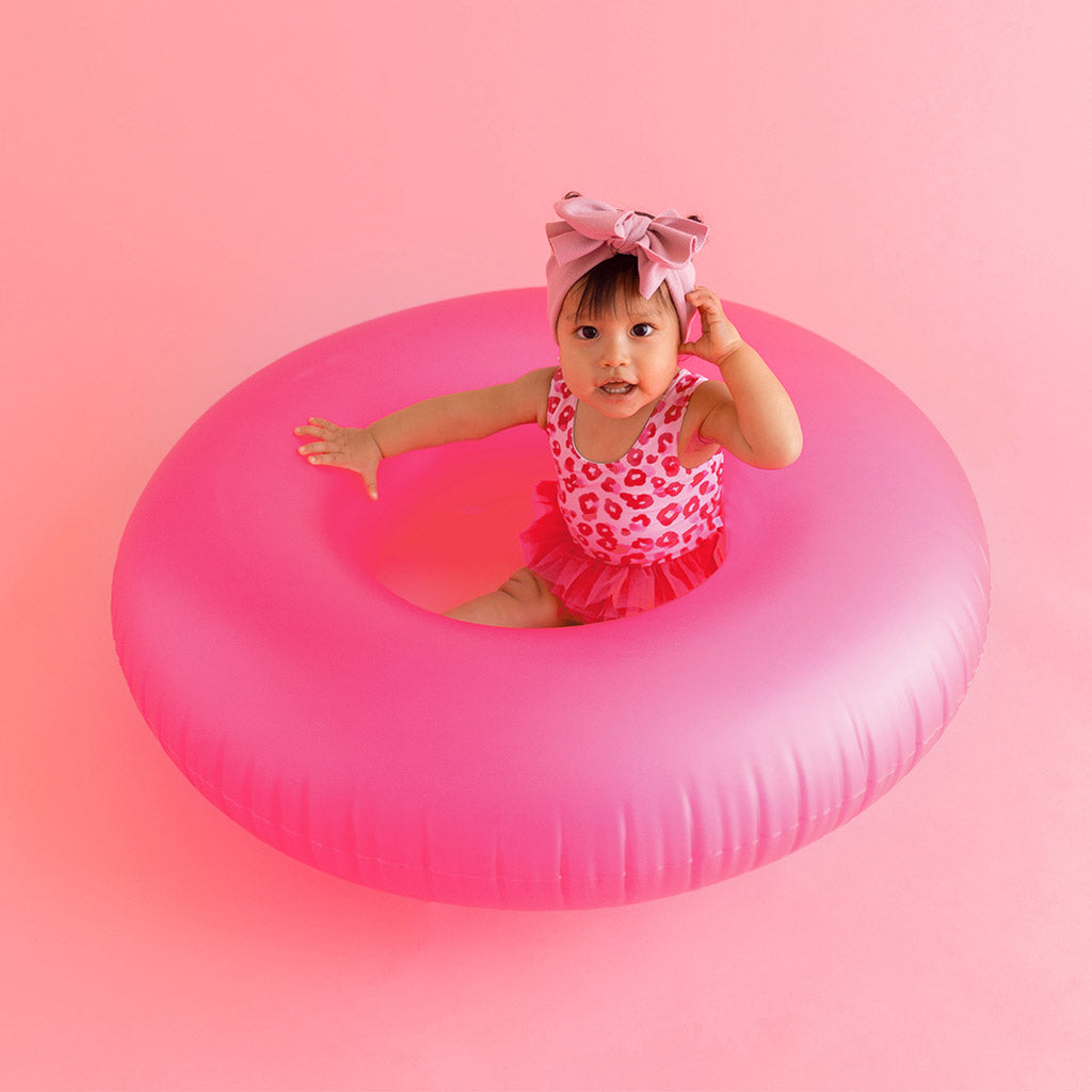 Baby in pink float tube