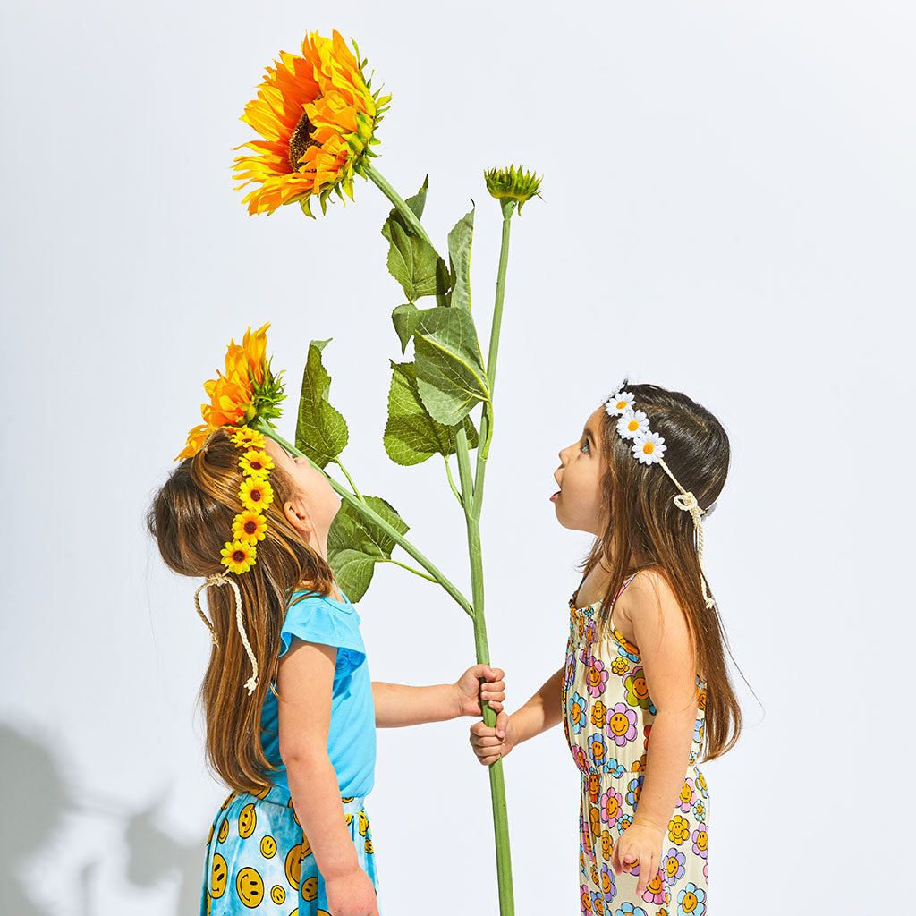 Toddler Girl Smiling with a Flower Crown on Her Head 