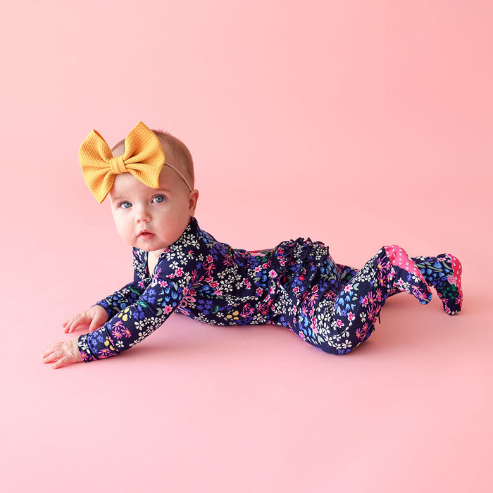 baby girl in one piece romper with bow