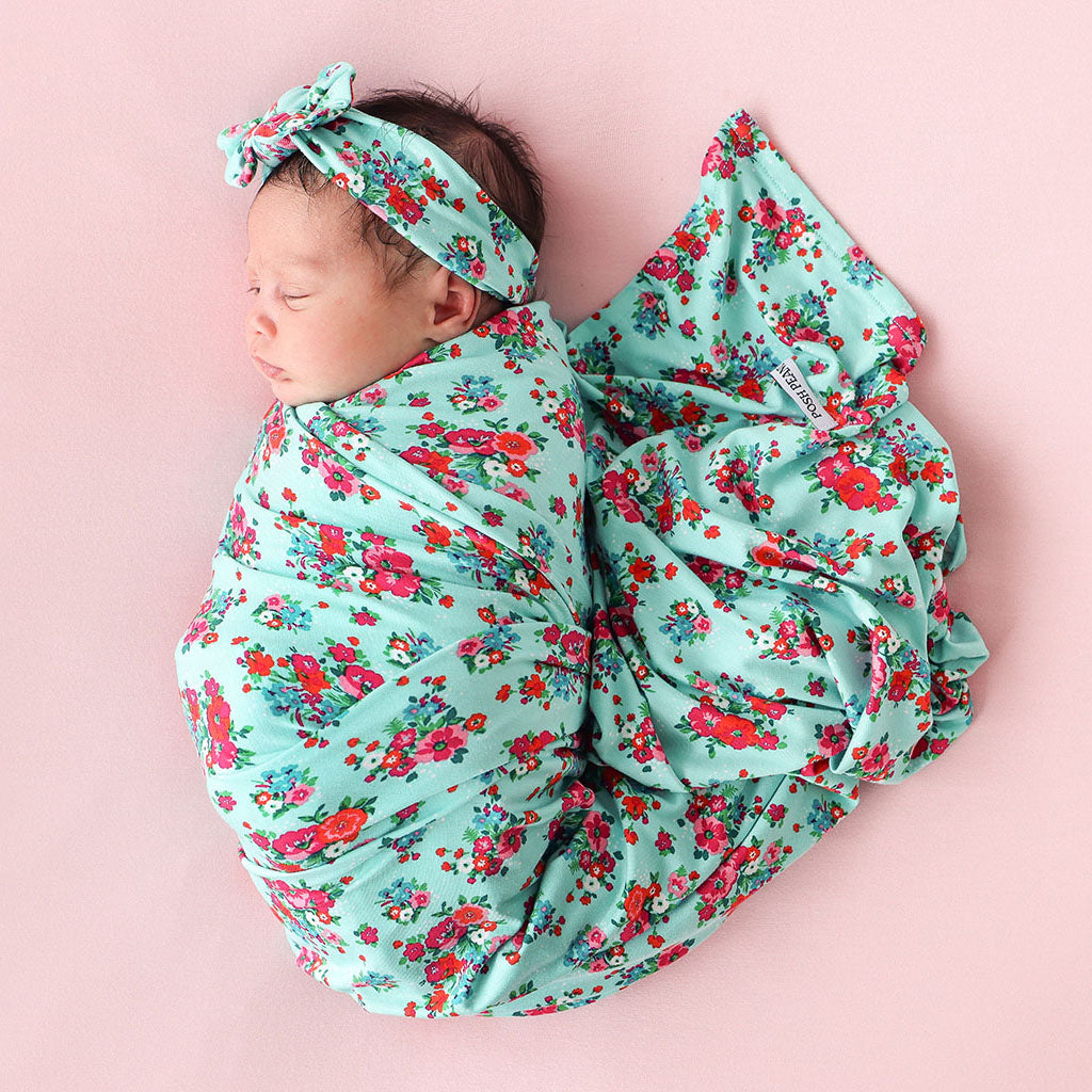 Baby girl in leopard onesie with headband sleeping 