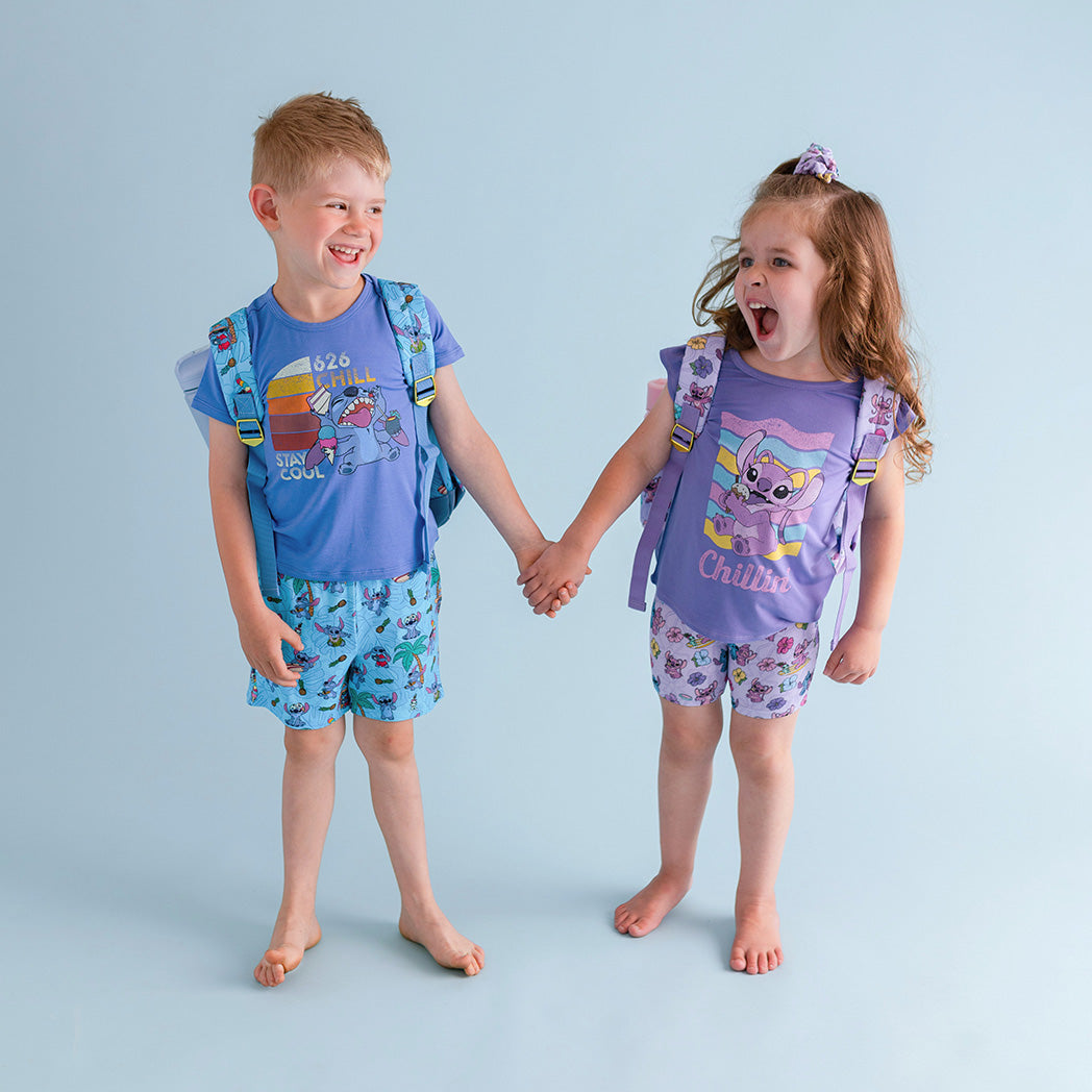 Siblings holding hands wearing Disney's Lilo and Angel prints 