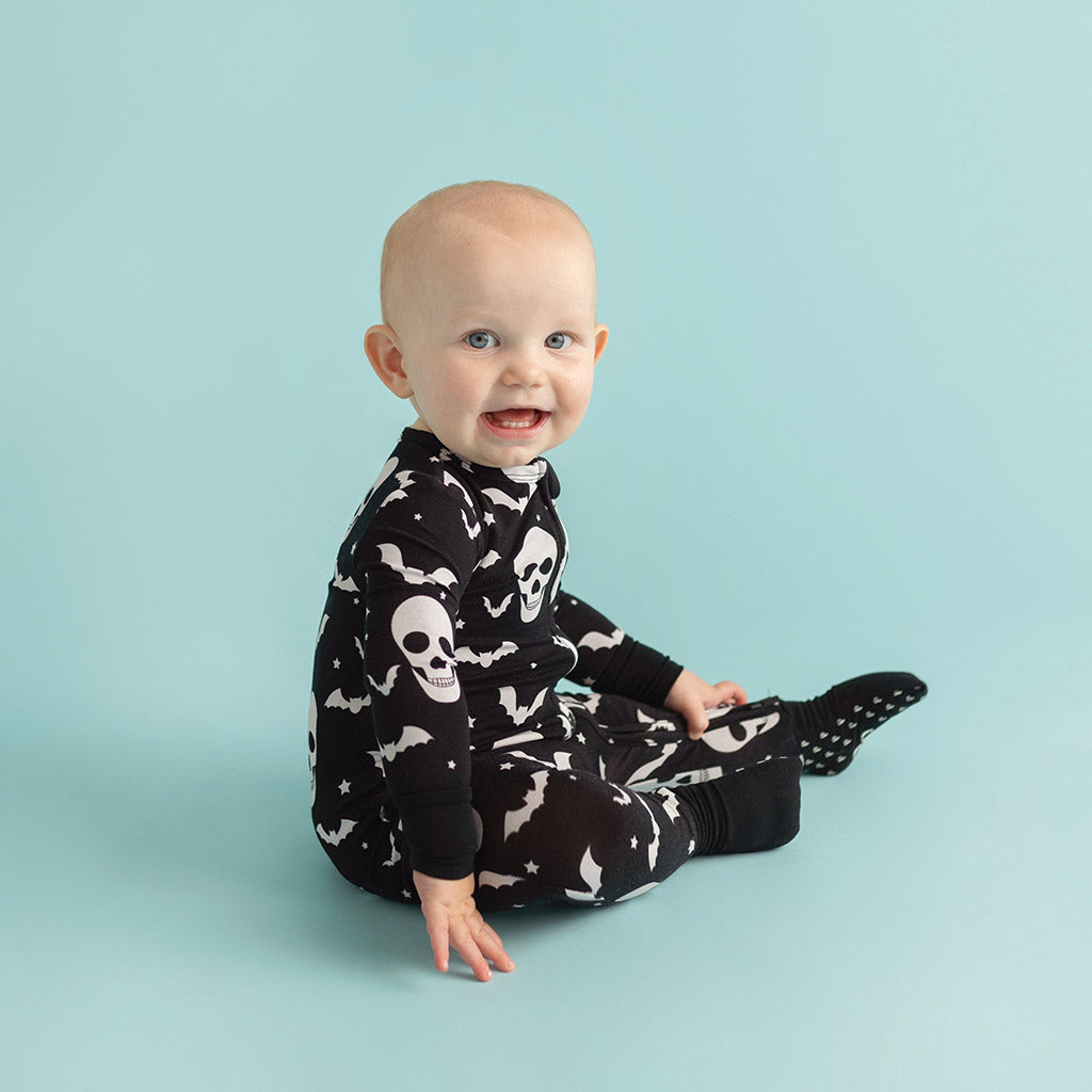 boy wearing halloween themed print onesie