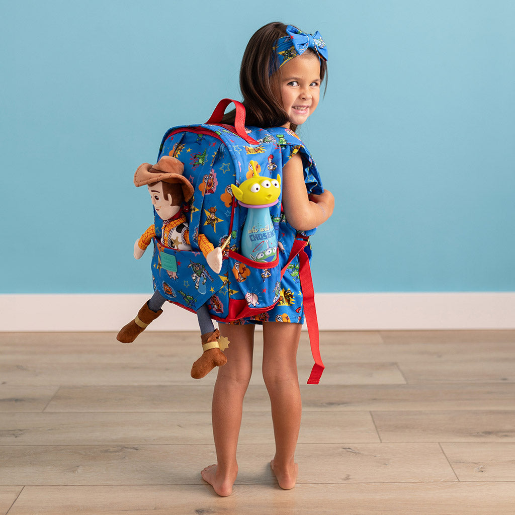 girl wearing Toy Story print backpack with matching outfit