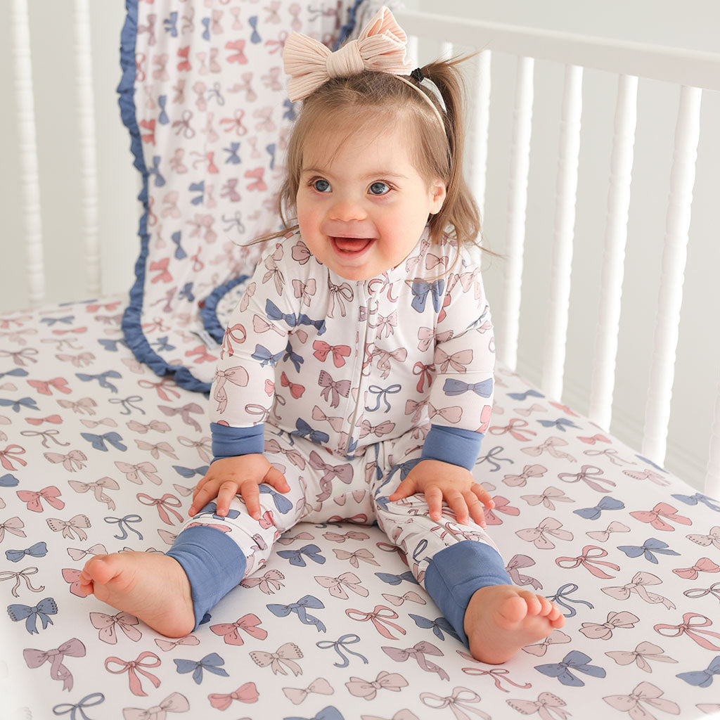 infant sitting up in crib