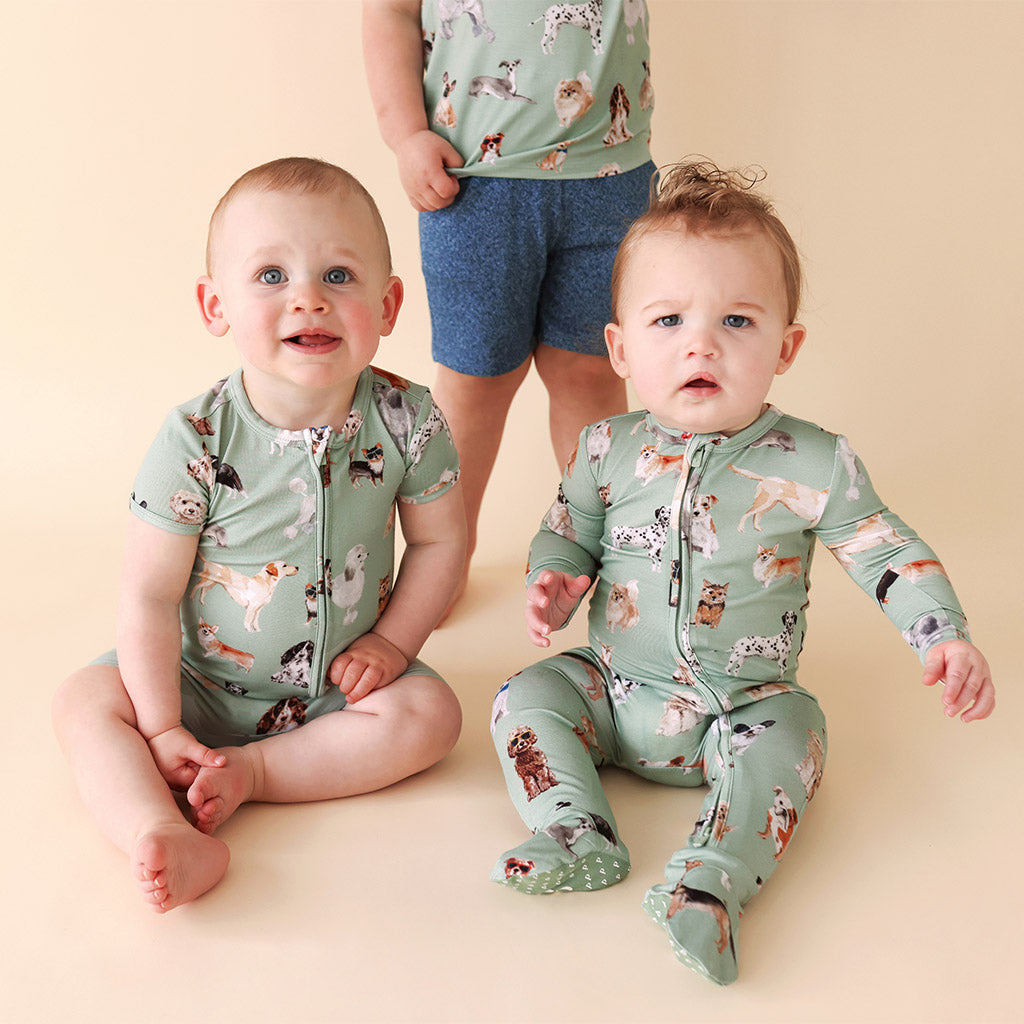 three children wearing matching dog print outfits