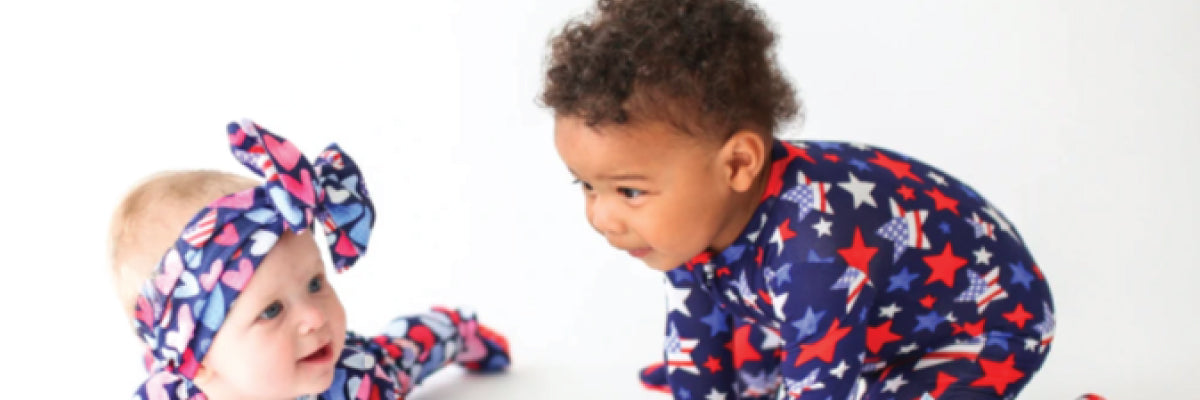 two kids wearing patriotic one piece baby clothing