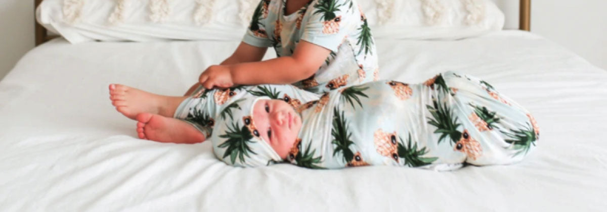 pineapple print baby boy swaddle blanket on bed