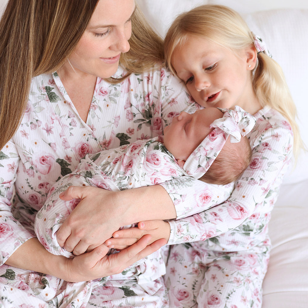 mom, daughter and infant in matching clothese