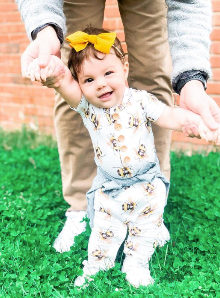 toddler wearing cute baby onesie with bee pattern by Posh Peanut