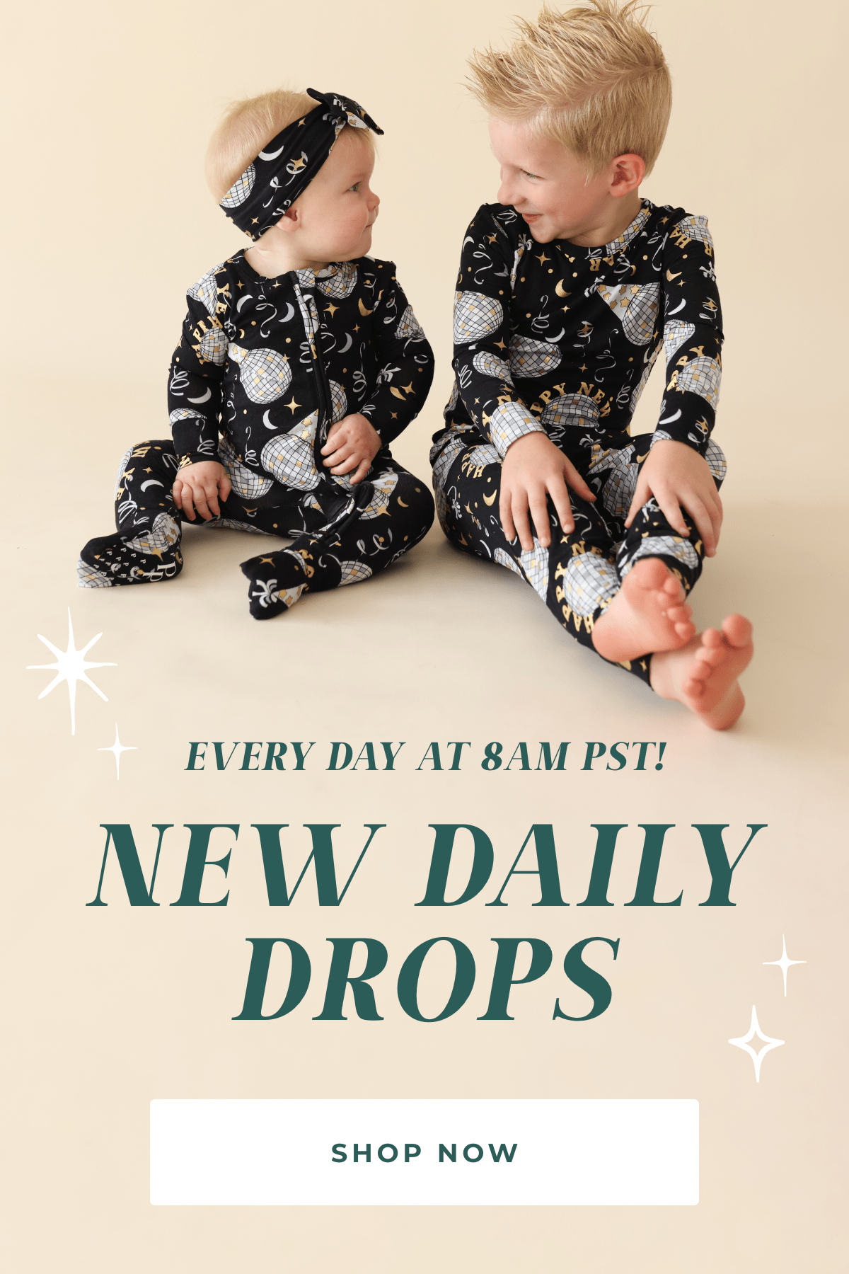 Two children in matching pajamas sitting on a light background with text 'Every Day At 8AM PST! New Daily Drops' and 'Shop Now'.