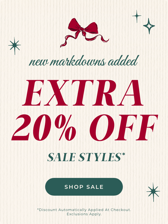 Promotional text for an extra 20% off sale on a beige background with text 'new markdowns added extra 20% off sale styles*' and 'Shop Sale' and '*Discount Automatically Applied At Checkout. Exclusions Apply.' with green star and red bow graphics