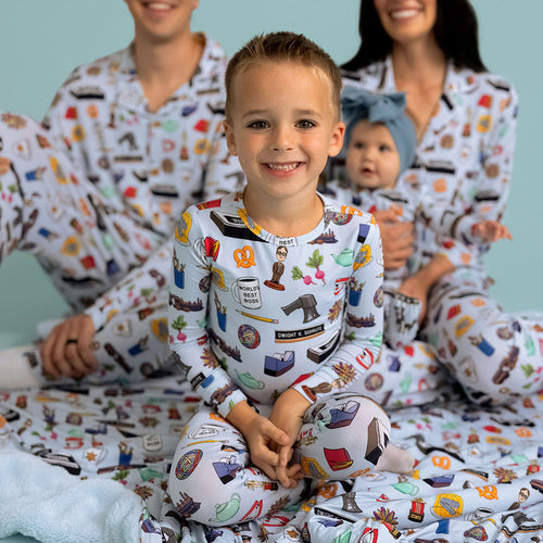 Family wearing matching pajamas with various designs on a light blue background