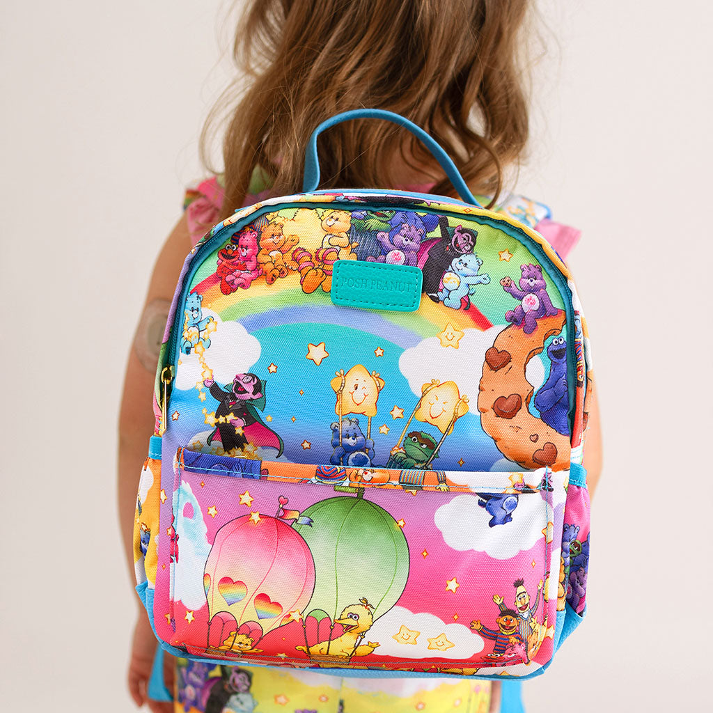 Colorful backpack with cartoon characters on a plain background