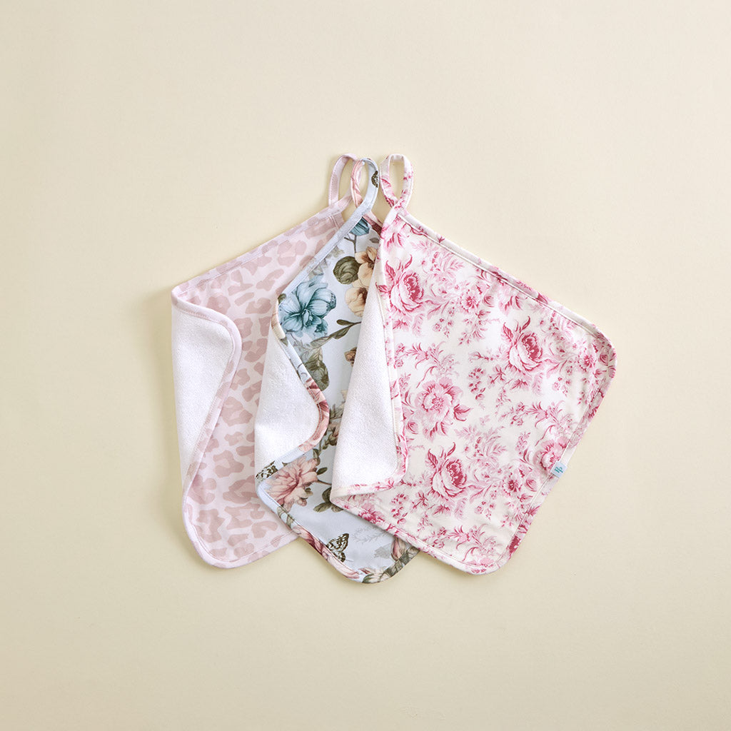 Set of floral-patterned washcloths on a beige background