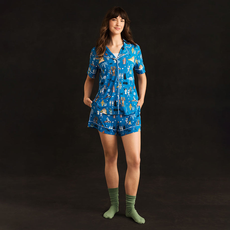 Adult wearing short pajama set with blue star wars print.