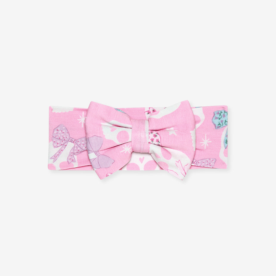 Flat lay of the Posh Peanut Ms. Kelly Luxe Bow Headwrap, white background