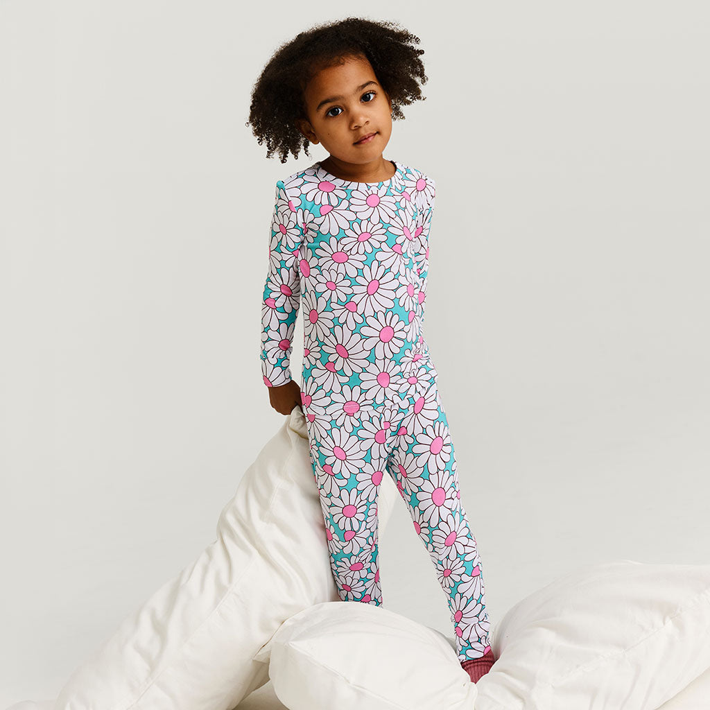 Child wearing a floral pajama set on a white background