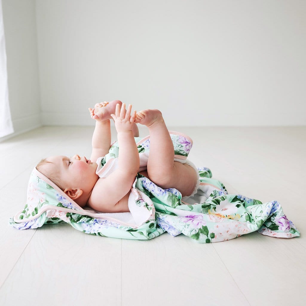 Baby playing on Erin Ruffled Hooded Towel